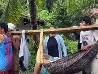 One of the victims being carried by rescuers in Malapatan, Sarangani.